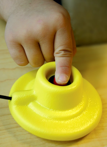 Photo of the Finger Isolation Button from the ATRC lending library.