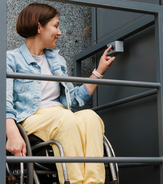 A person using a wheelchair ramp at home