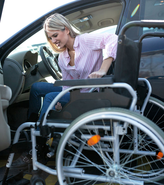 A woman transferring out of a wheelchair