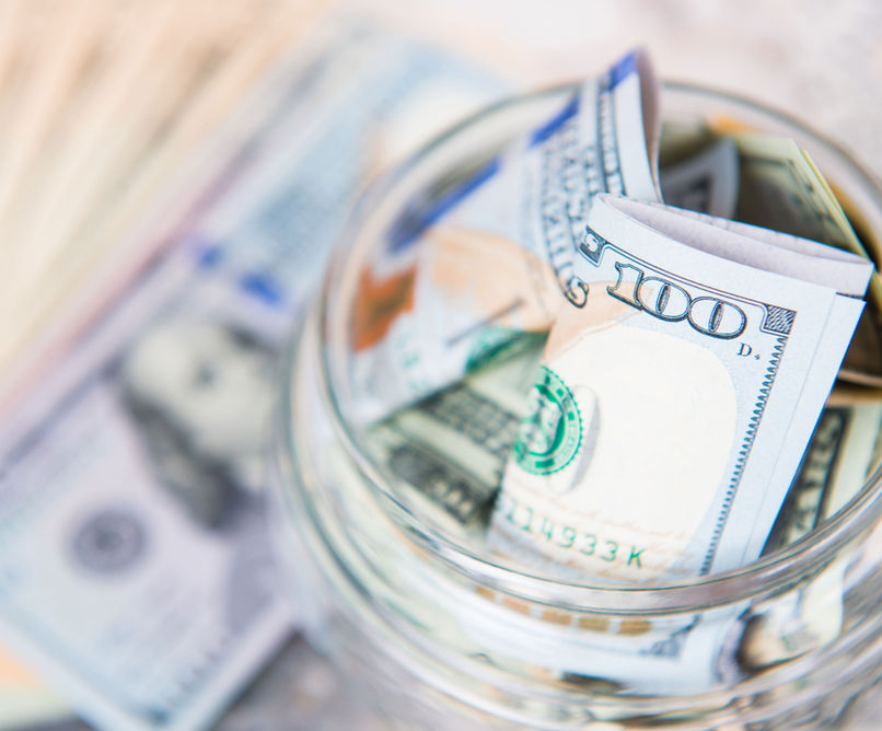 A jar of cash saved towards a purchase